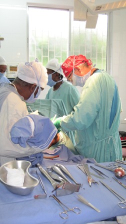 Dr. Meyer and Dr. Lyimo preparing to insert an artificial hip at the Machame orthopedic surgical theater
